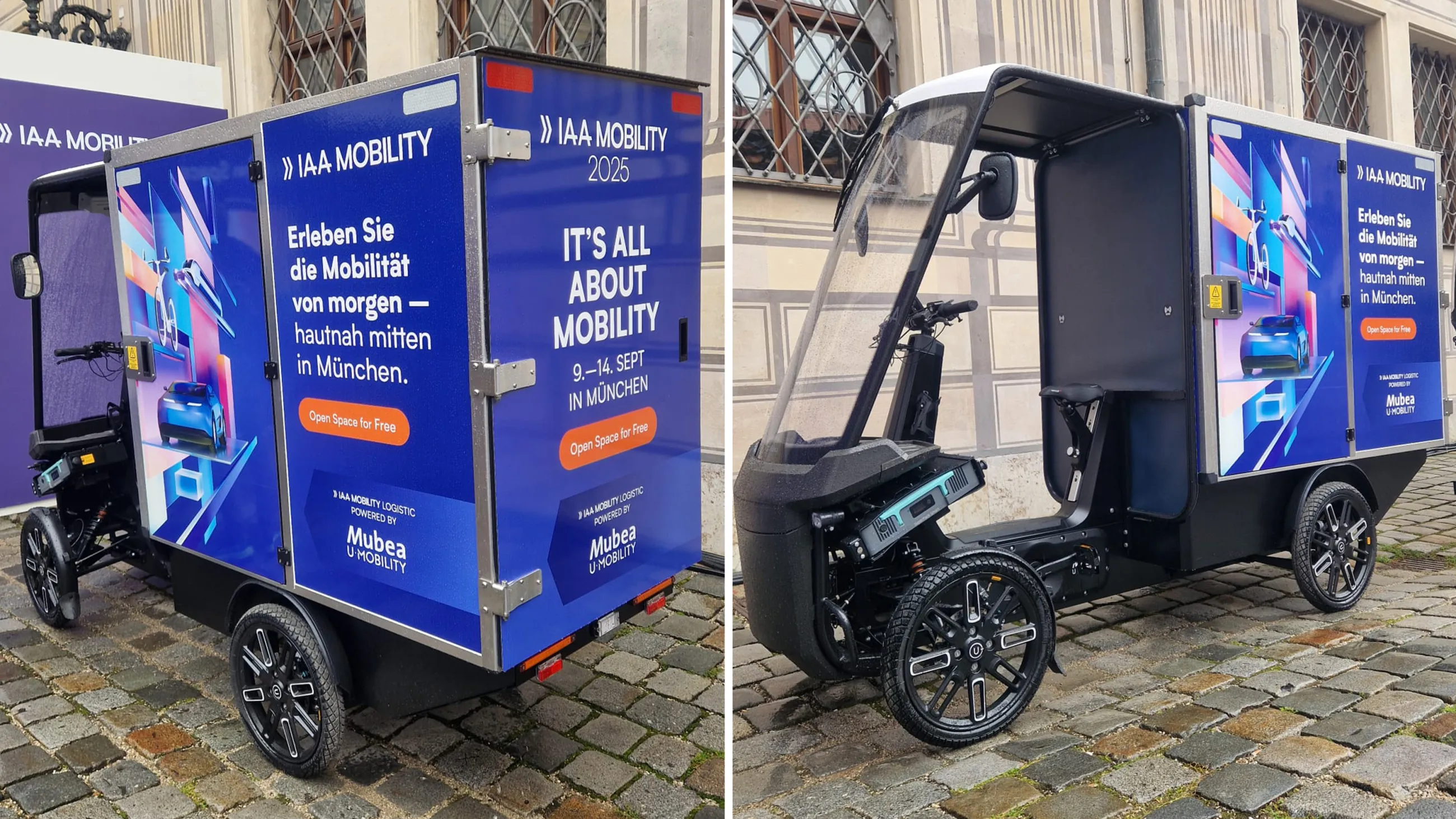 Mubea eCargobike with IAA Mobility branding on cobblestones in front of a historic building.